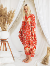 a woman in a red floral print robe