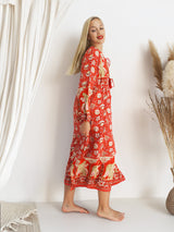 a woman standing in front of a white wall