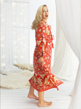 a woman in a red dress standing in a room