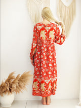 a woman standing in front of a white wall