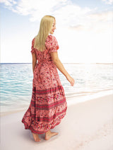 a woman standing on a beach next to the ocean