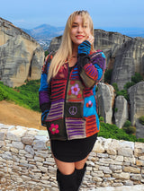 a woman in a colorful jacket talking on a cell phone