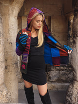 a woman in a black dress and a colorful jacket