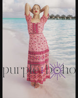 a woman standing on a beach next to the ocean