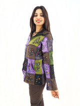 a woman in a colorful jacket posing for a picture