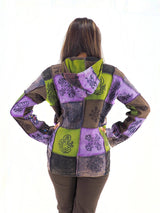 a woman wearing a jacket with a colorful design on it