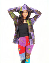 a woman in a colorful patchwork jacket and leggings