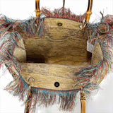 a handbag with a fringed handle and handles