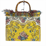 a yellow purse with a floral design on it