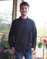 a man standing on a porch next to a table