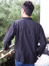 a man standing on a balcony looking at the trees