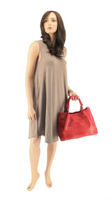 a female mannequin holding a red purse