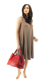 a woman in a brown dress holding a red purse