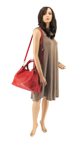 a female mannequin holding a red purse
