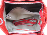 the inside of a red purse with a red strap