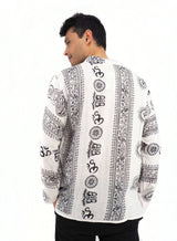 a man wearing a white shirt with a black and white pattern