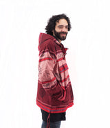 a man with curly hair wearing a red jacket