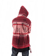 a person wearing a red and black jacket with a hood