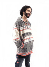 a man with curly hair wearing a shirt and jeans