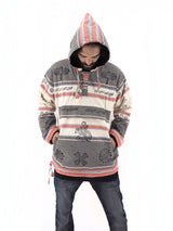 a man in a striped hoodie is looking at his cell phone