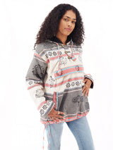a woman in a sweater and jeans posing for a picture