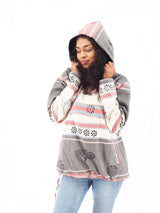 a woman in a hoodie talking on a cell phone