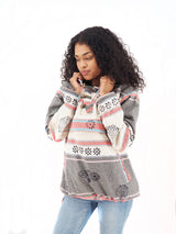 a woman in a sweater talking on a cell phone