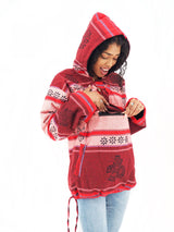a woman in a red hoodie looking at her cell phone