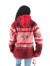 a woman wearing a red jacket with a bee on it