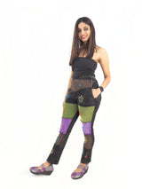 a woman in a black top and colorful pants