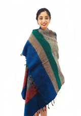 Large Yak Wool Shawl Blanket with bold striped design, wrapped elegantly. Ethically handmade, ideal for warmth, meditation, or as a stylish throw.