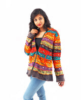 a woman in a colorful jacket posing for a picture