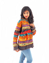 a woman in a colorful jacket posing for a picture