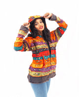 a woman in a colorful jacket is posing for a picture