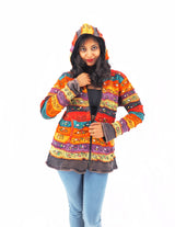 a woman in a colorful jacket posing for a picture