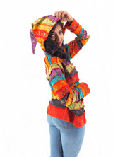 a woman in a colorful jacket posing for a picture