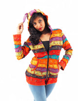 a woman in a colorful jacket posing for a picture