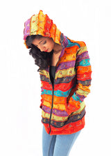 a woman wearing a colorful jacket and jeans