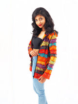 a woman in a colorful jacket posing for a picture