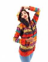 a woman in a colorful jacket posing for a picture