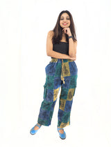 a woman posing for a picture in a black top and blue pants