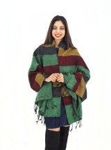 Luxurious yak wool shawl blanket in green, red, yellow, and black tones. Hand-loomed for warmth and versatility in any season.