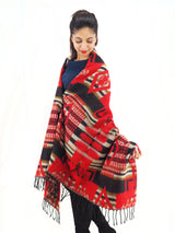 a woman wearing a red and black blanket