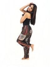 a woman in a black tank top and patterned pants