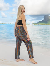 a woman standing on a beach next to a body of water