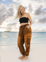 a woman standing on a beach with her hands in her pockets