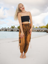 a woman standing on a beach next to a body of water