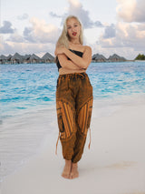 a woman standing on a beach with her arms crossed