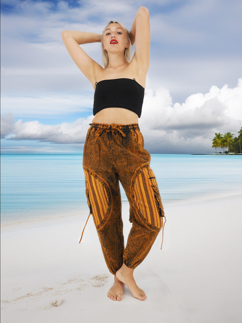 a woman standing on a beach with her arms behind her head