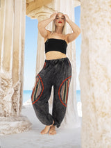 Boho yoga pants with vibrant designs by columns